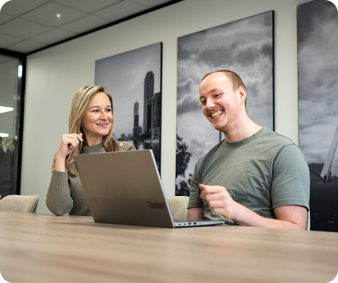 Twee medewerkers lopen door een modern kantoor